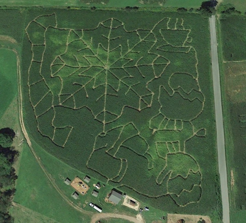 Corn maze design depicting a snowflake surrounded by winter clothing articles